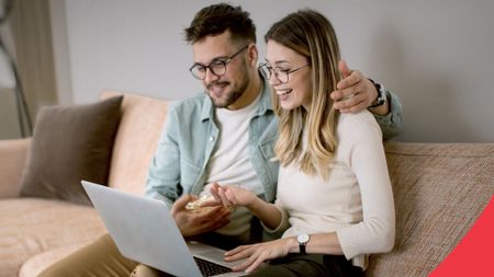 Couple wearing glasses on laptop