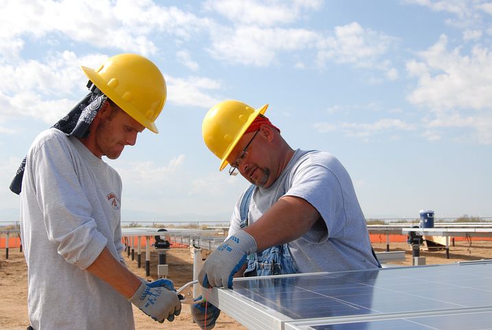 two men installing 3 phase solar inverter